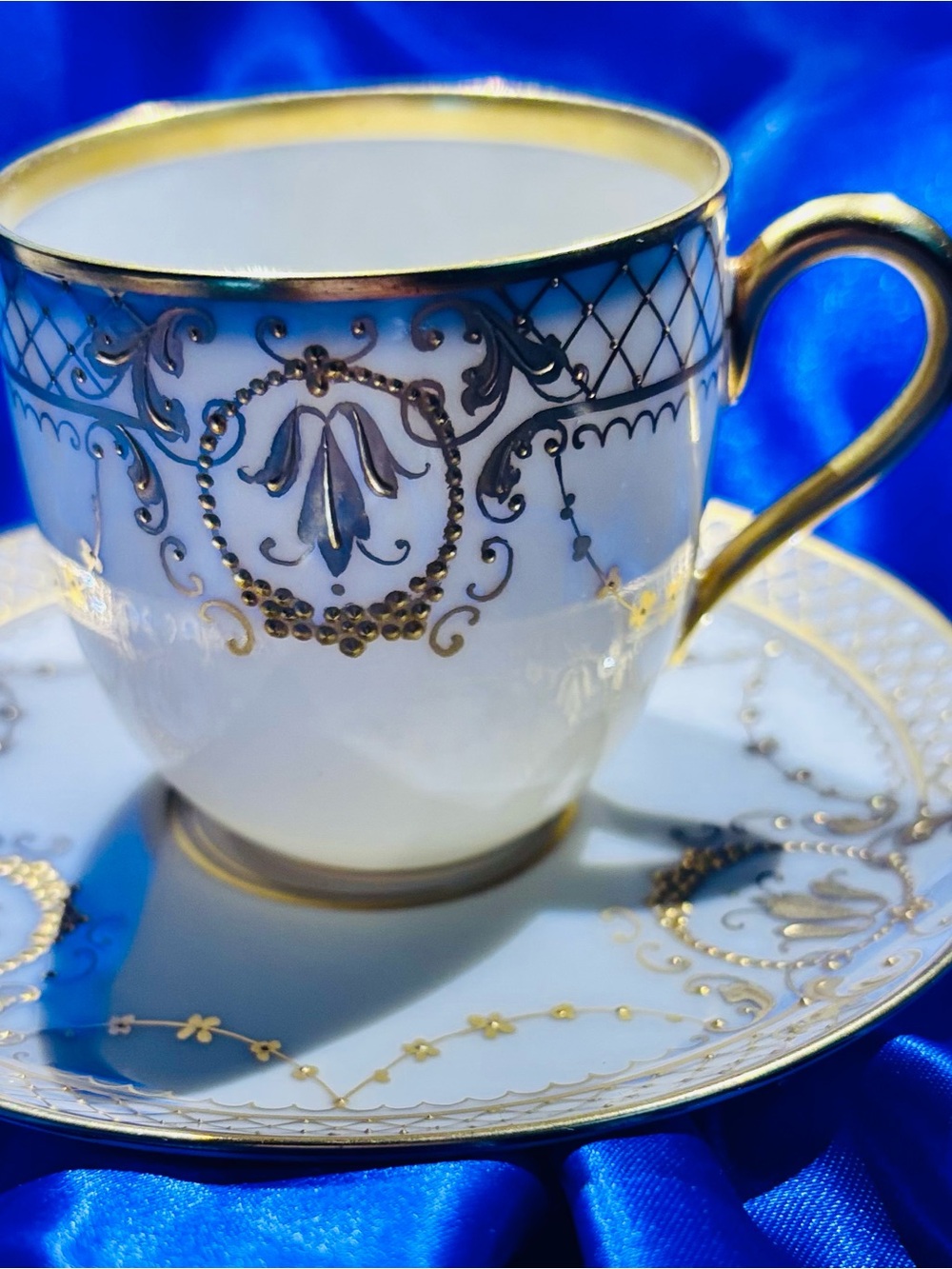 Hutschenreuther White and Gold Porcelain Dimitasse & Saucer w/ raised 22k gold.